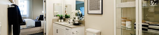a bathroom with a toilet and a sink and a mirror