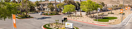 a street with an intersection and palm trees and houses at THE CLUBS AT RHODES RANCH APARTMENT HOMES, Las Vegas