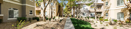 courtyard and apartment buildings at THE CLUBS AT RHODES RANCH APARTMENT HOMES, Las Vegas, NV