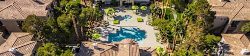 a birds eye view of a house with a pool and trees at THE CLUBS AT RHODES RANCH APARTMENT HOMES, Las Vegas, NV