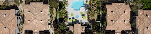 a birdseye view of a group of houses with a pool in the middle at THE CLUBS AT RHODES RANCH APARTMENT HOMES, Nevada