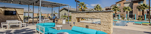 A sunny day at the outdoor seating area with a stone fireplace.