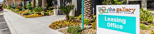 A leasing office sign is displayed in front of a building.