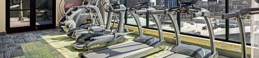 A gym with treadmills and elliptical machines.