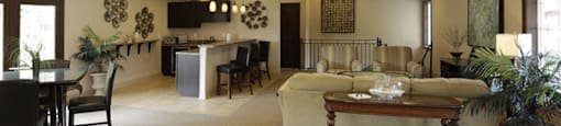 a living room filled with furniture and a ceiling fan