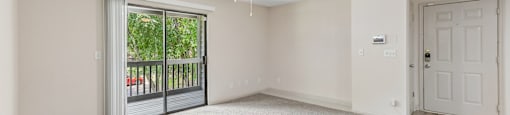 A room with a ceiling fan and carpeted floor.