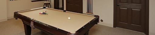 a pool table in a room with two doors
