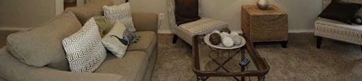 a living room filled with furniture and a mirror