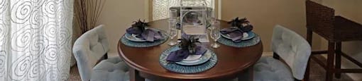 a dining room with a table and chairs and a chandelier