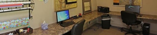 a room with two computers on a long counter