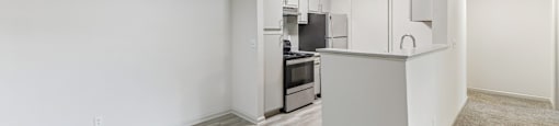 A kitchen area with a refrigerator, microwave, and oven.
