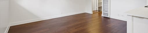 A room with wooden floors and white walls.