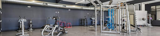 A gym with a grey floor and a white ceiling.