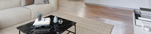 Spacious living room with hardwood-style flooring at Place at Midway apartments in Douglasville near Lithia Springs, GA