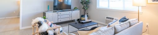 Pet-Friendly Apartments in Tigard OR - Sygnii - Furnished Living Room with Plank Flooring and a Window with Blinds