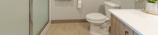 a bathroom with a toilet a sink and a shower