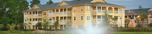 Hinesville, GA Apartments – Tattersall Village - pond with fountain in front of community building