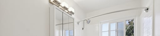 A white bathroom with a toilet, sink, and bathtub.