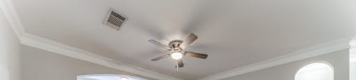 Apartments in San Antonio, TX for Rent - Club at Stone Oak - Unfurnished Living Room Space with Hardwood Floors, a Ceiling Fan, Grey Walls, Alcove, Windows, and a Spacious Layout