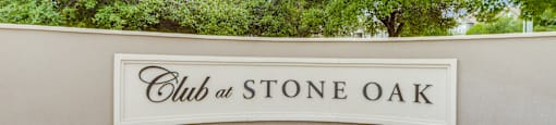 a sign that says club at stone oak