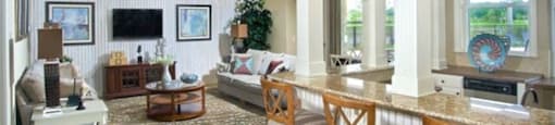 Hinesville, GA Apartments – Tattersall Village - clubhouse with sitting are and TV and bar area