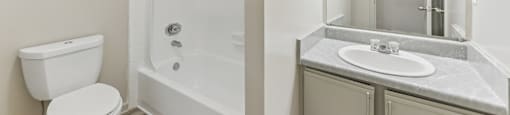 A white toilet sits next to a white sink in a bathroom.