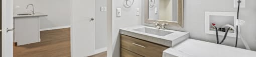 A white bathroom with a washer and dryer.