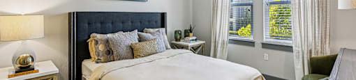 Spacious bedroom with large windows and ceiling fan at Lotus at Starkey Ranch in Odessa, Florida.