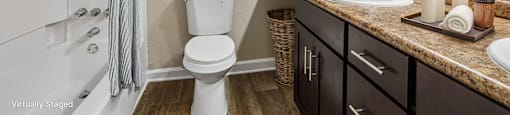 A bathroom with a white toilet, a sink, and a mirror.