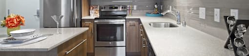 a kitchen with wooden cabinets and stainless steel appliances