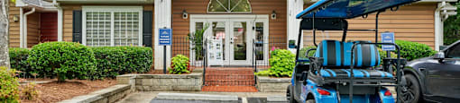 A small building with a red roof and a sign on the front door.