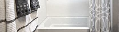 a bathroom with a shower and a toilet and towels