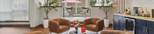 A living room with brown chairs and a white table.