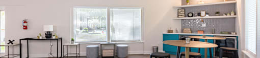 a living room filled with furniture and a large window