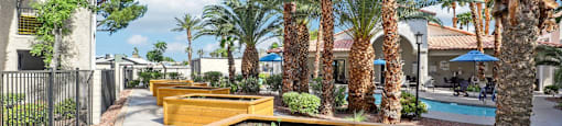 A row of wooden planters are lined up on a sidewalk.