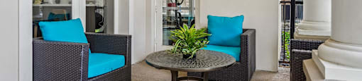 A patio with a table and two chairs.