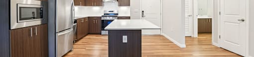 A modern kitchen with wooden cabinets and a central island.