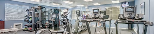 a gym with treadmills and other exercise equipment