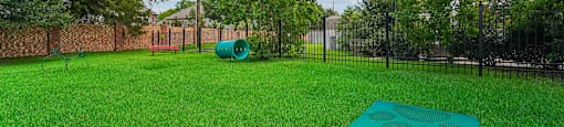 A green park with a bench and a slide.
