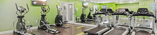 A gym with treadmills and exercise bikes.