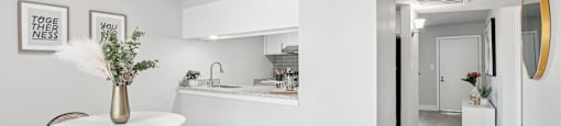 A white bathroom with a round table and chairs.