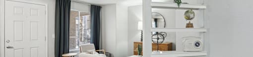 A white couch sits in a room with a white wall and a white door.