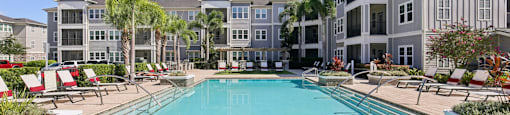 Outdoor swimming pool with clear blue water and lounge chairs at Lotus at Starkey Ranch in Odessa, Florida.
