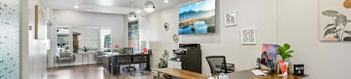 A reception area with a desk and chairs.
