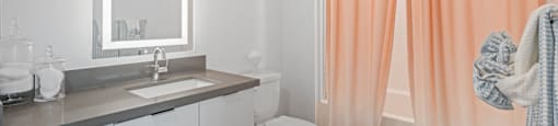 A bathroom with a toilet, sink, and shower curtain.