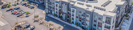 A parking lot is in the foreground of a city scene.