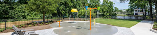 Outdoor splash pad and seating area at Somerset Apartments in Charlotte, NC, perfect for residents of studio, 1, 2, and 3 bedroom apartments