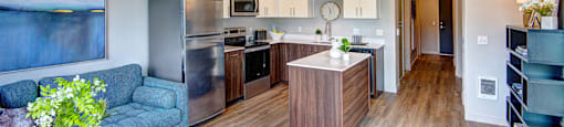 Bothell, WA Apartments for Rent - Open-Concept Kitchen with Wood Flooring, Stainless Steel Appliances, and Mobile Island