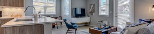 a kitchen and living room with a couch and a coffee table