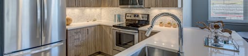 a kitchen with wooden cabinets and stainless steel appliances